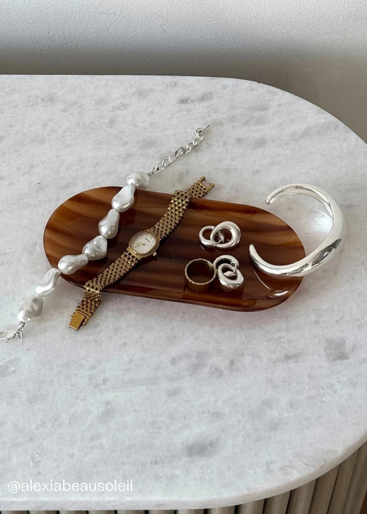 Vanity setup featuring the Kov Essentials Tray holding hair clips and jewelry