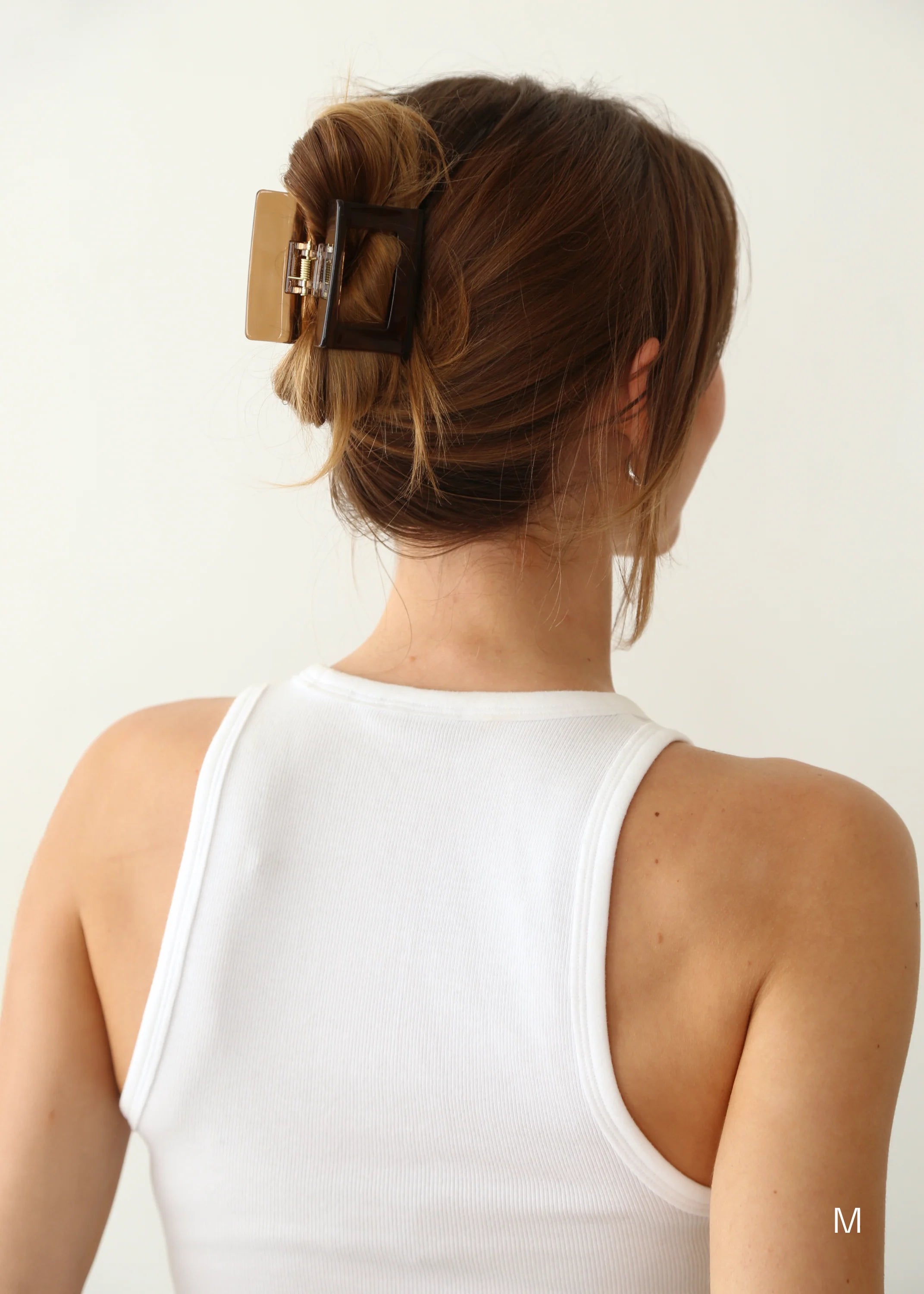 Model wearing Kov Essentials Soul Clip in a French twist updo