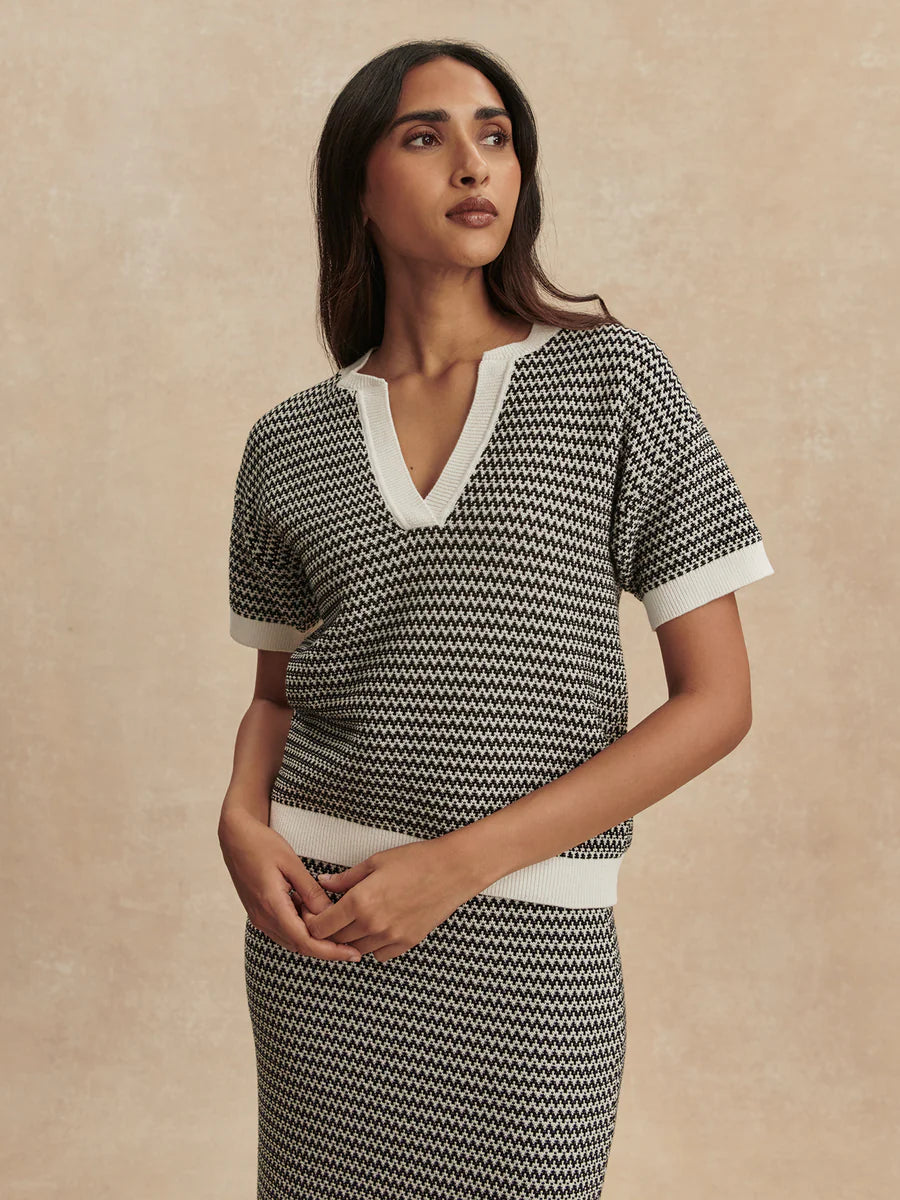 Varley Dora short-sleeve knit polo top in Snow White with black contrast tipping on the collar and sleeves.