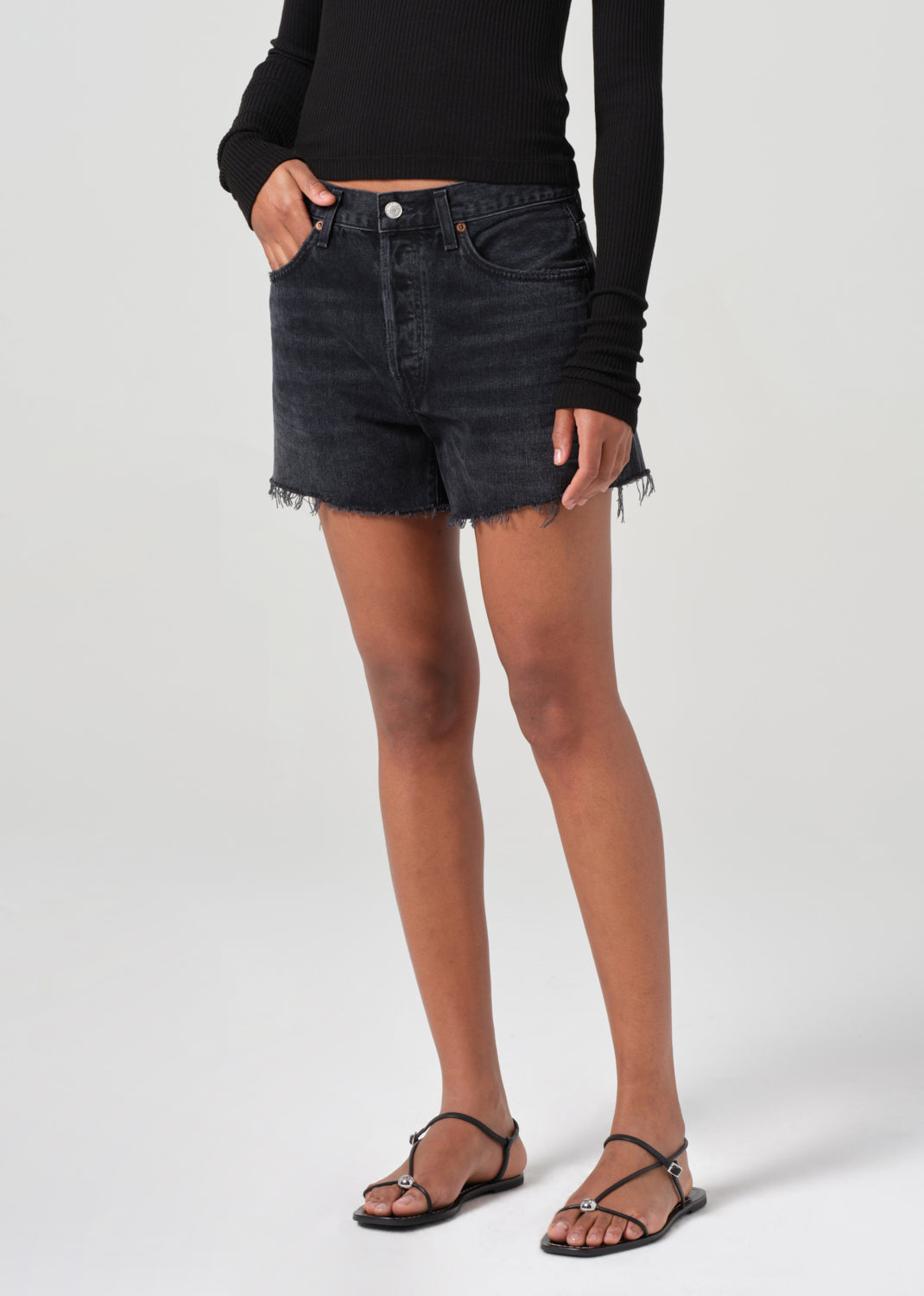 Saturated black mid thigh short with raw hems
