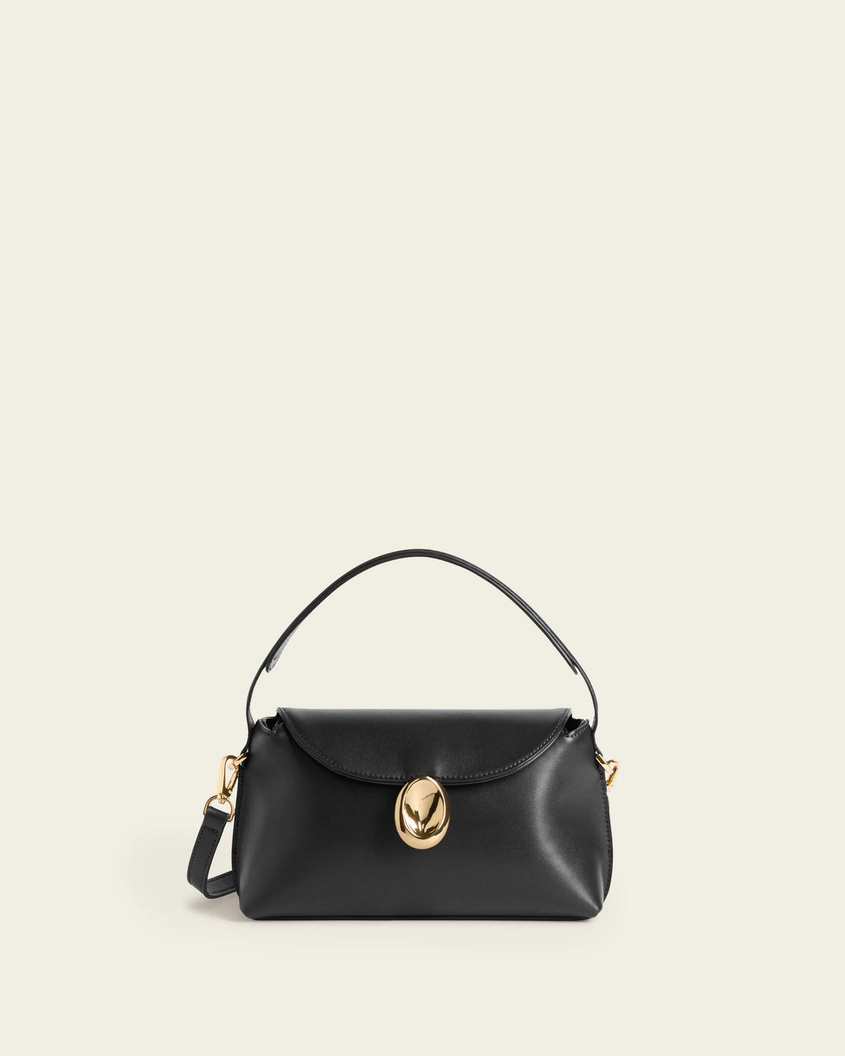 Flattered Gaia mini black leather handbag with top handle and crossbody strap.
