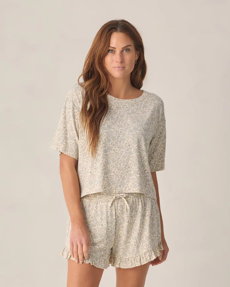 Rylee + Cru Women's Mosie two-piece lounge set in natural cream with a blue meadow floral print and ruffle-trimmed shorts.