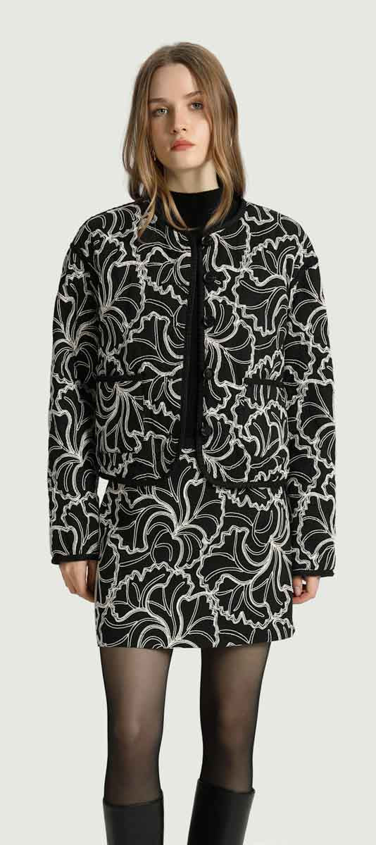 KORNER Eloise black cropped collarless jacket with white graphic botanical print.