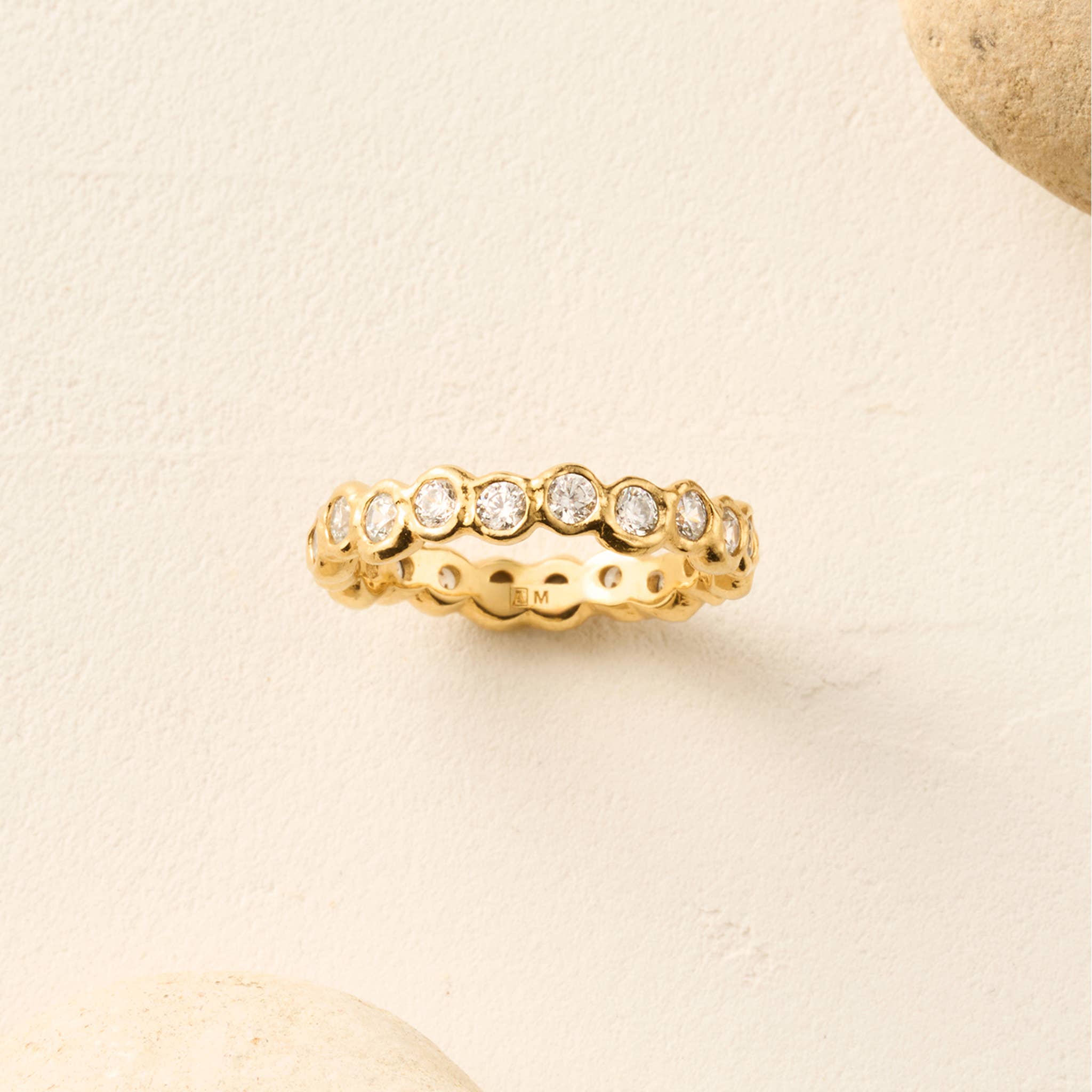 Agapée Amélia II geometric eternity ring in satin gold plating featuring beaded white cubic zirconia stones.