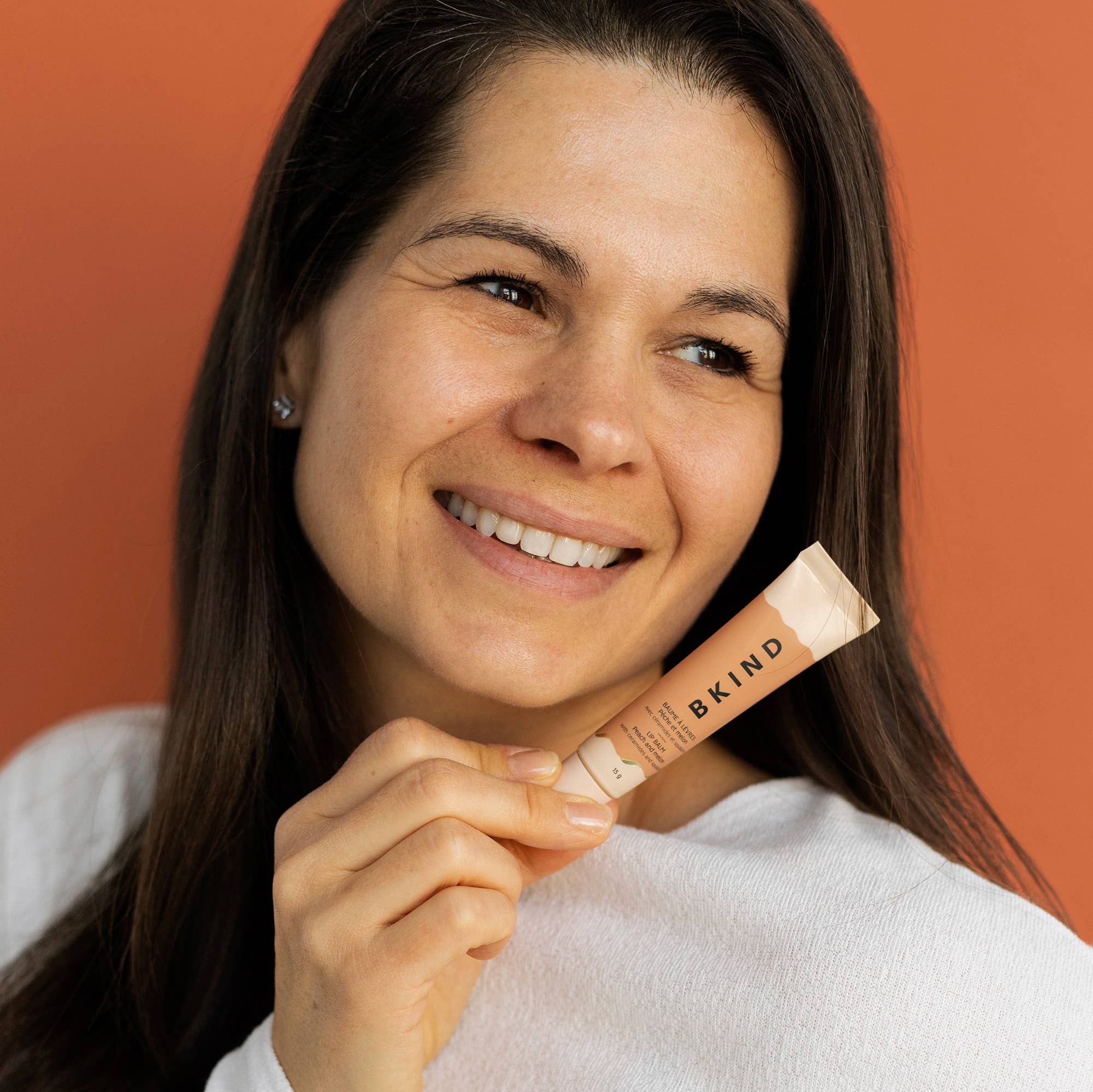 BKIND Nourishing Ceramide Lip Balm tube in Peach and Melon scent