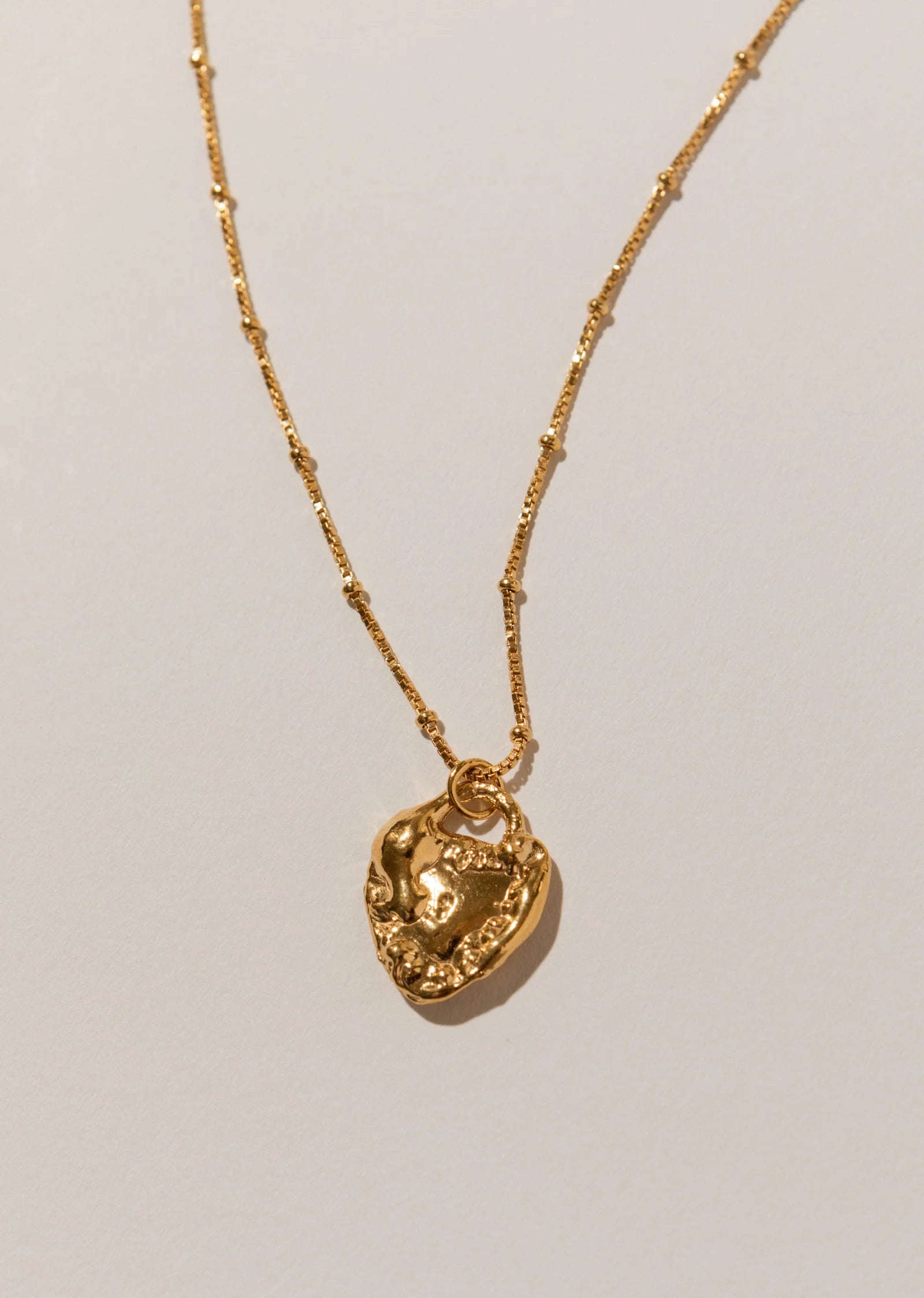 Pamela Card Unveiled Love 24K gold vermeil locket pendant necklace.