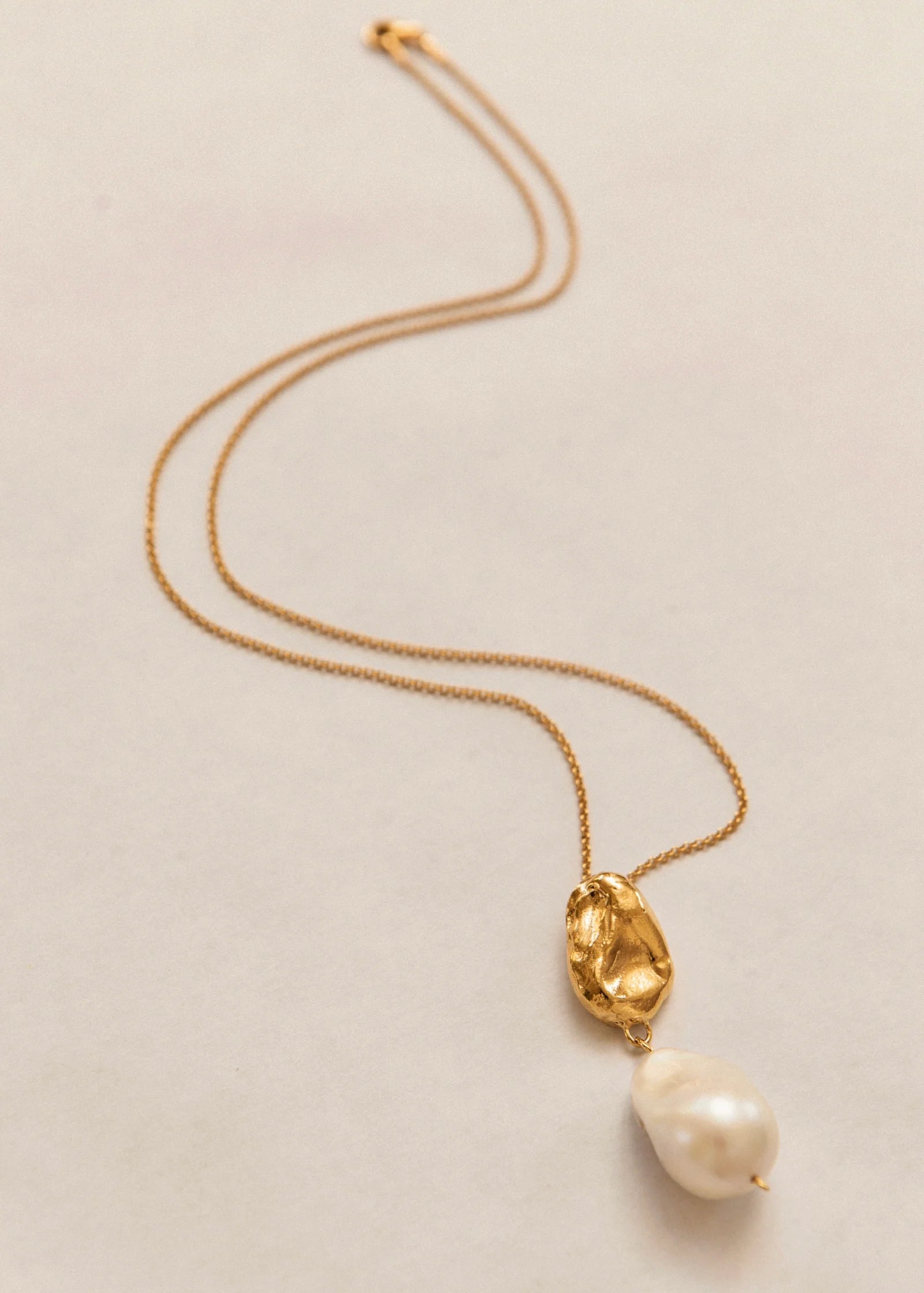 Pamela Card Infinite Terrazza 24K gold necklace with a molten wax-cast pendant and large baroque pearl.