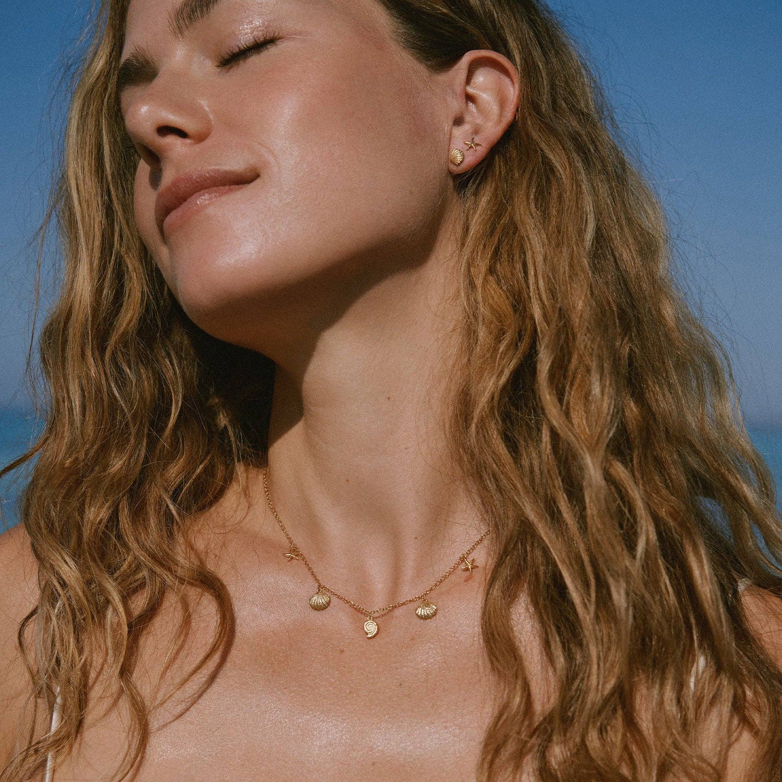 Agapée Almé small gold seashell stud earrings with satin finish