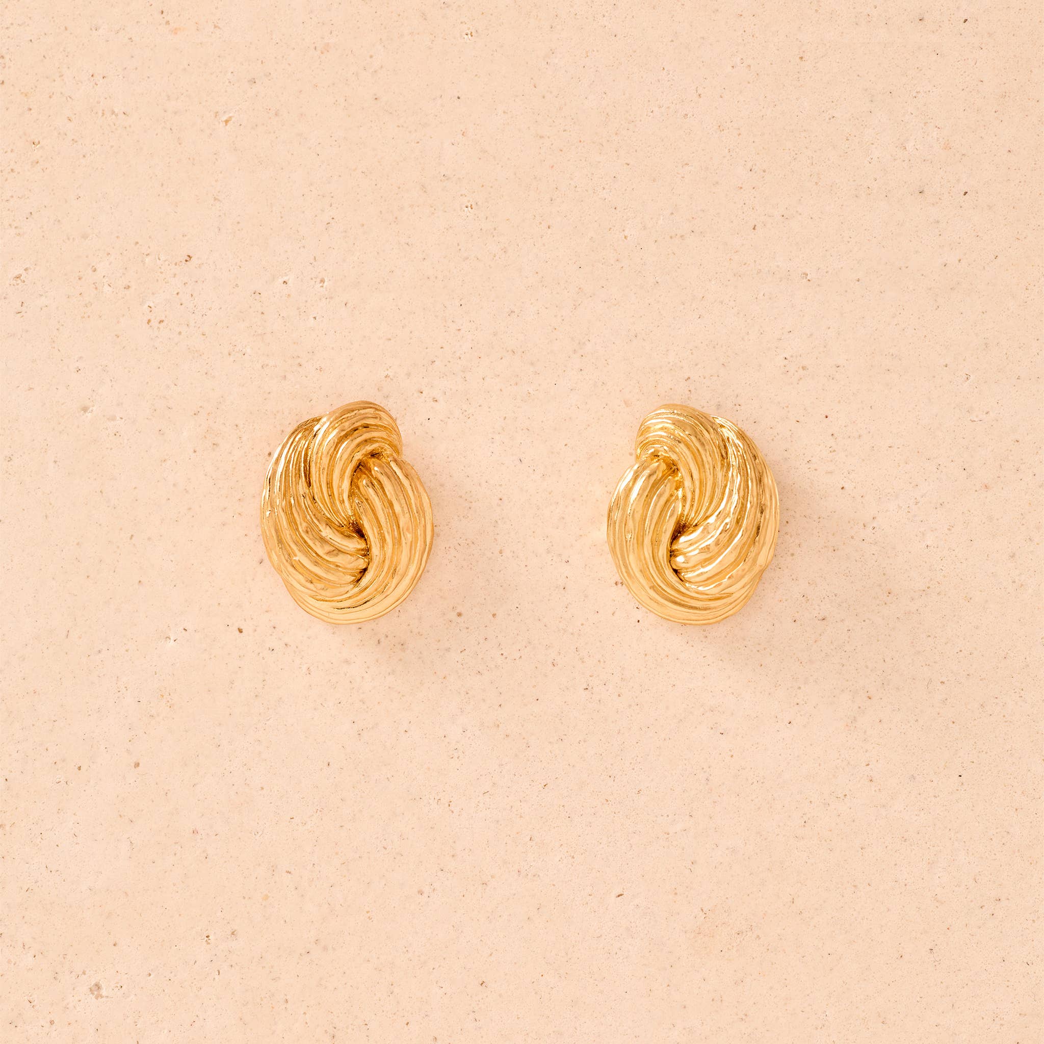 Agapée Claudia chunky gold twist knot earrings with ridged texture