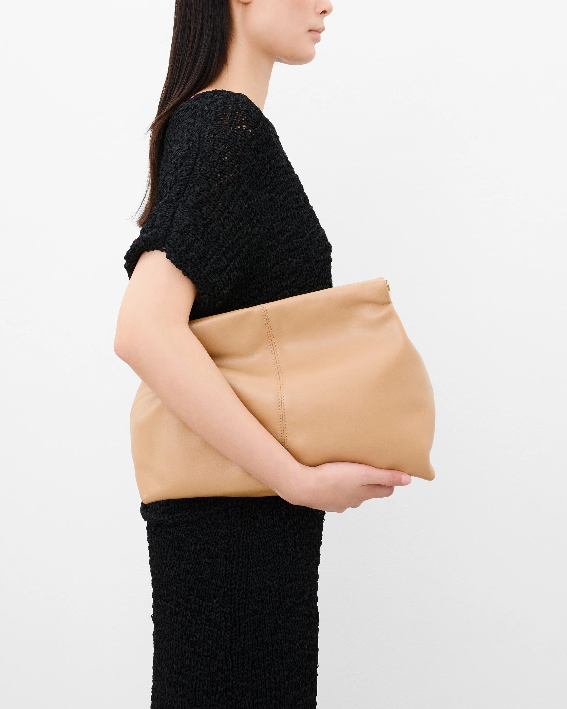Close-up of Clay Leather Clutch in Biscotti showing Italian calf leather texture and top closure