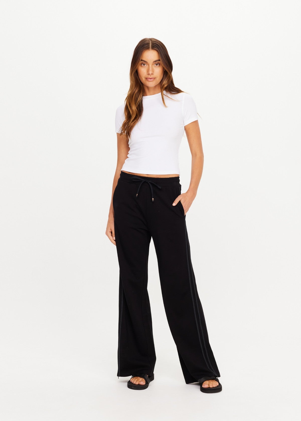 The Upside Roma high-rise pants in classic black featuring an elasticated drawstring waist and delicate side lace taping.