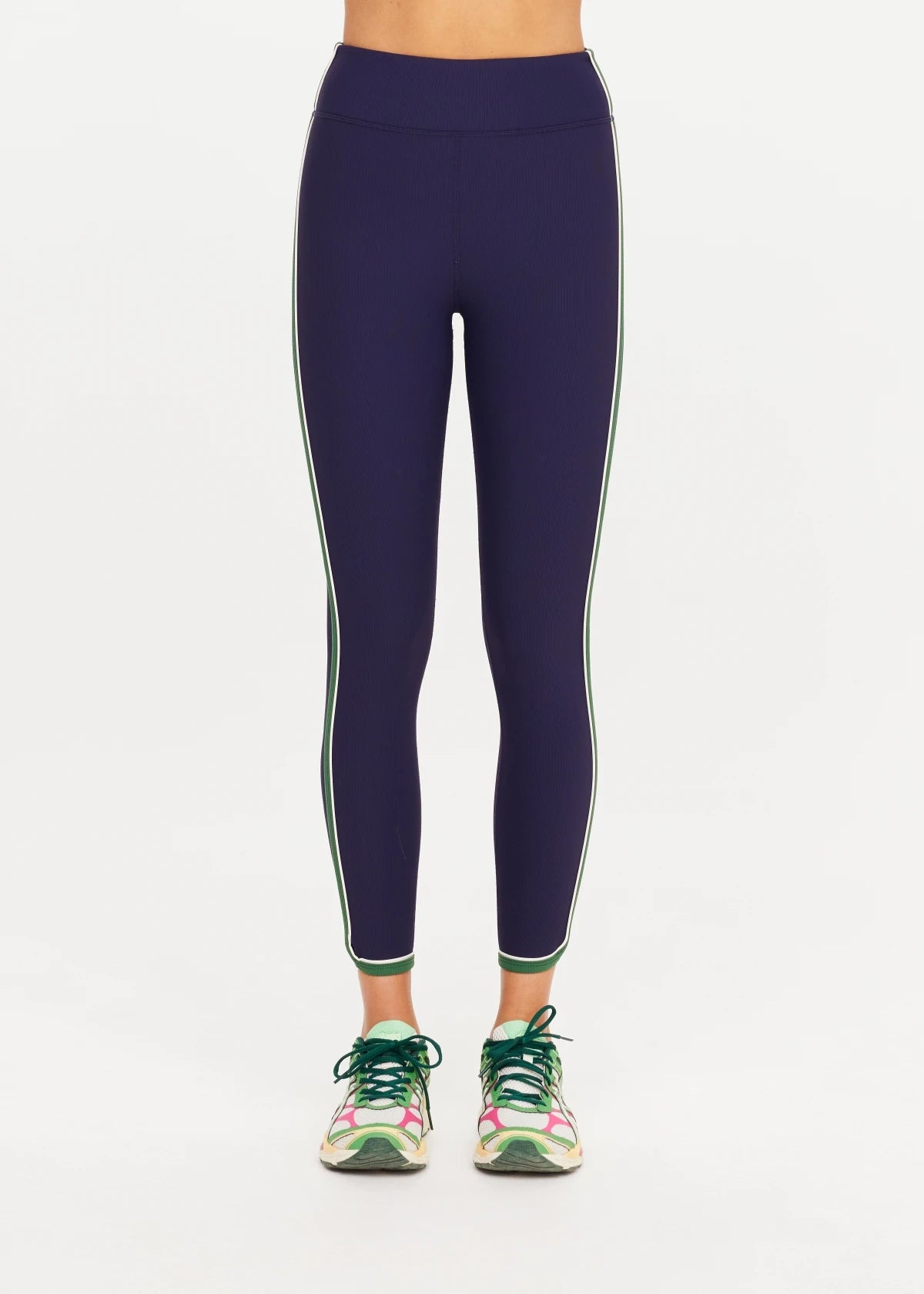 The Upside Rhythm 25-inch high-rise 7/8 active leggings in navy blue with side piping.