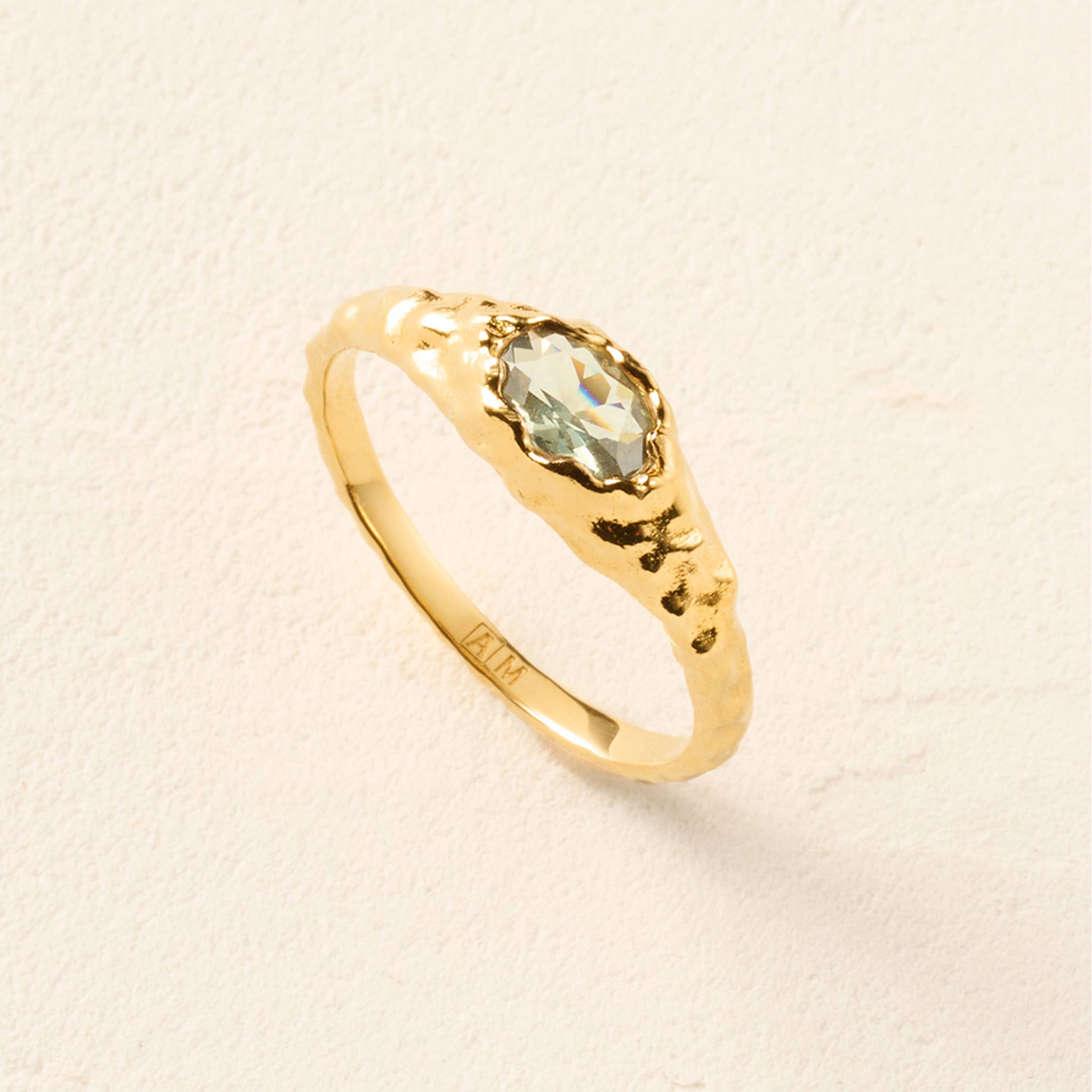 Agapée Maria Mini thin hammered gold dome ring featuring a faceted oval celadon blue-green stone in an organic setting.