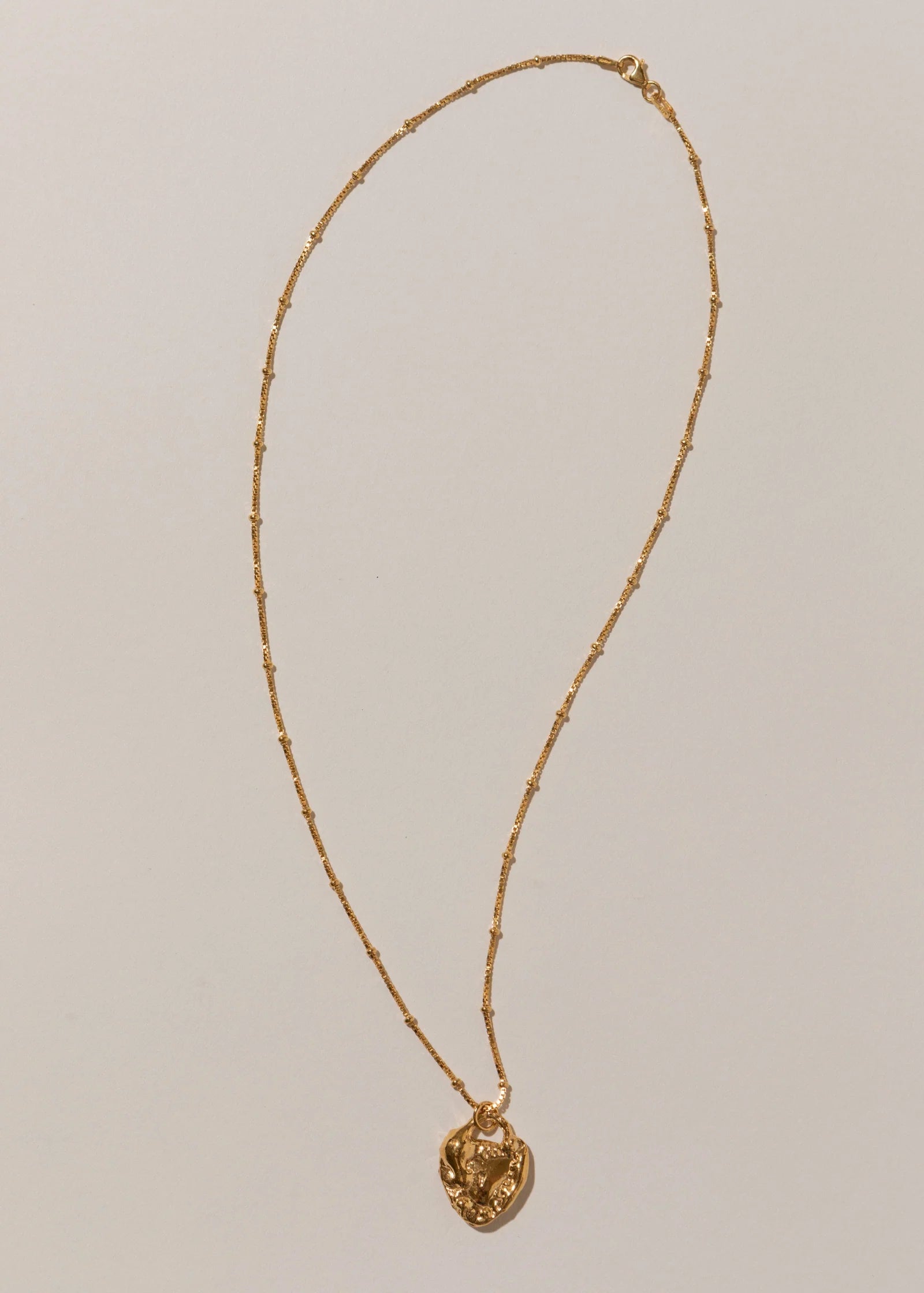 Pamela Card Unveiled Love 24K gold vermeil locket pendant necklace.