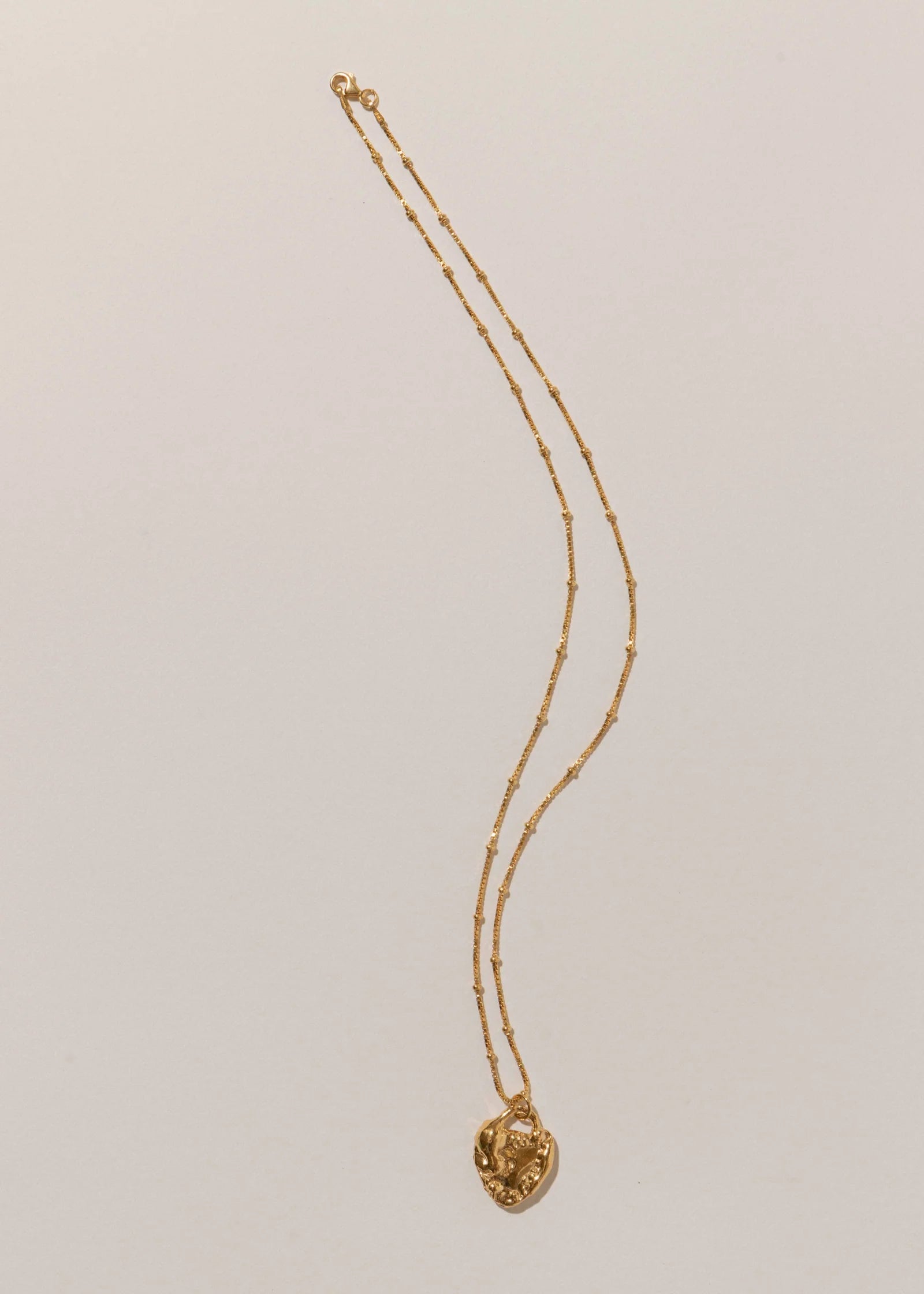 Pamela Card Unveiled Love 24K gold vermeil locket pendant necklace.