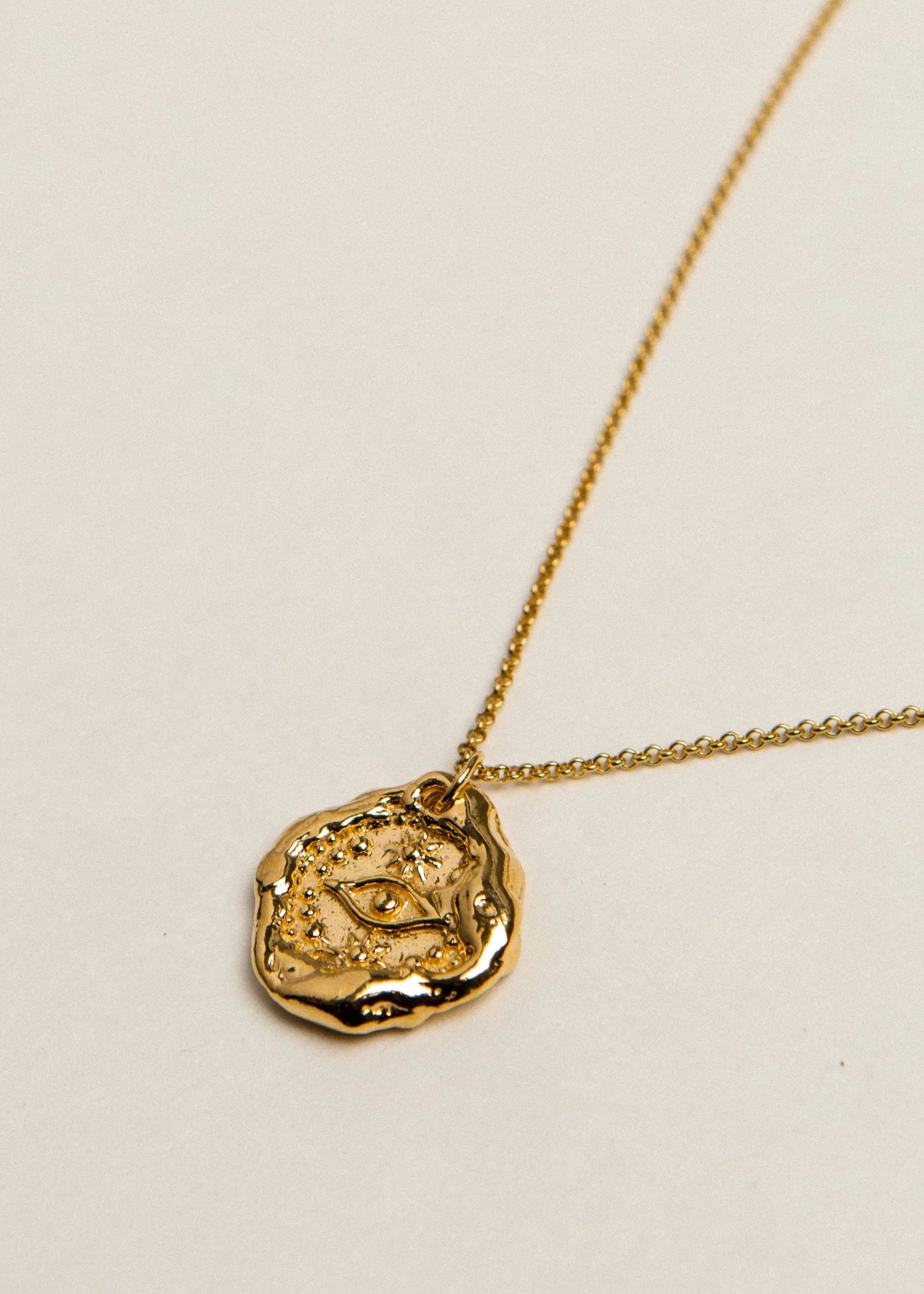 Pamela Card Her Watchful Gaze gold nazar amulet necklace with molten edges.