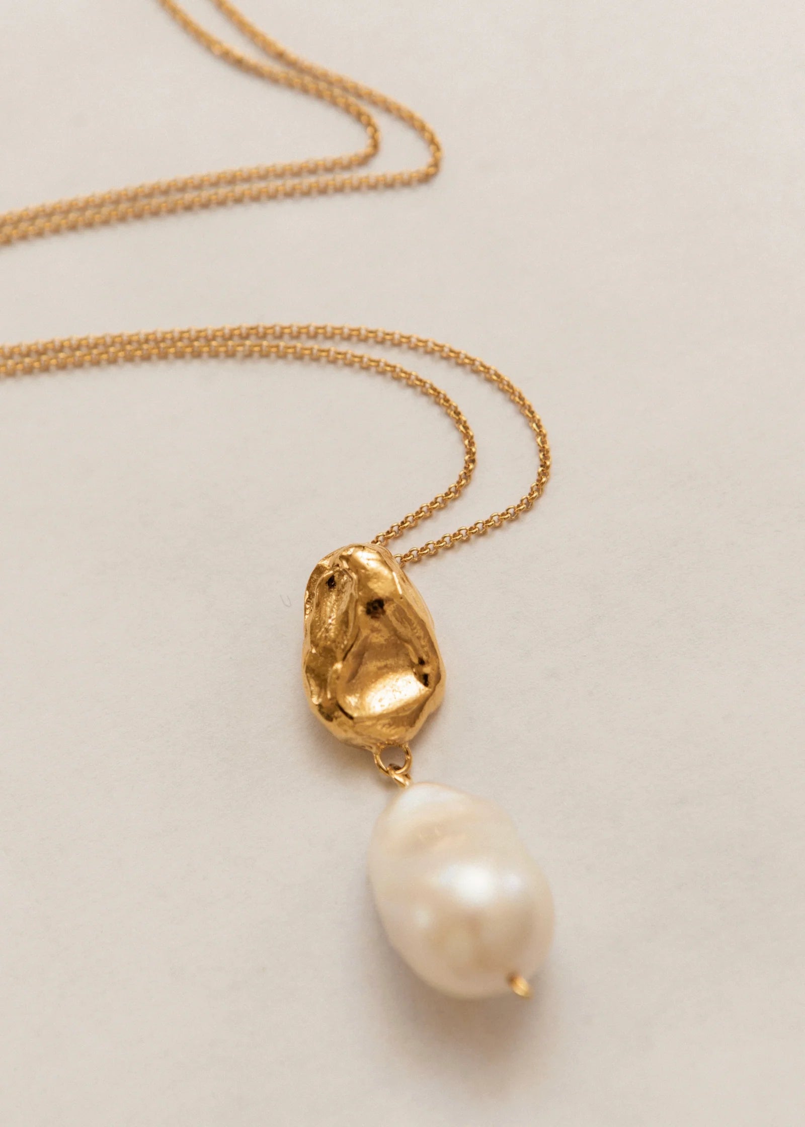 Pamela Card Infinite Terrazza 24K gold necklace with a molten wax-cast pendant and large baroque pearl.
