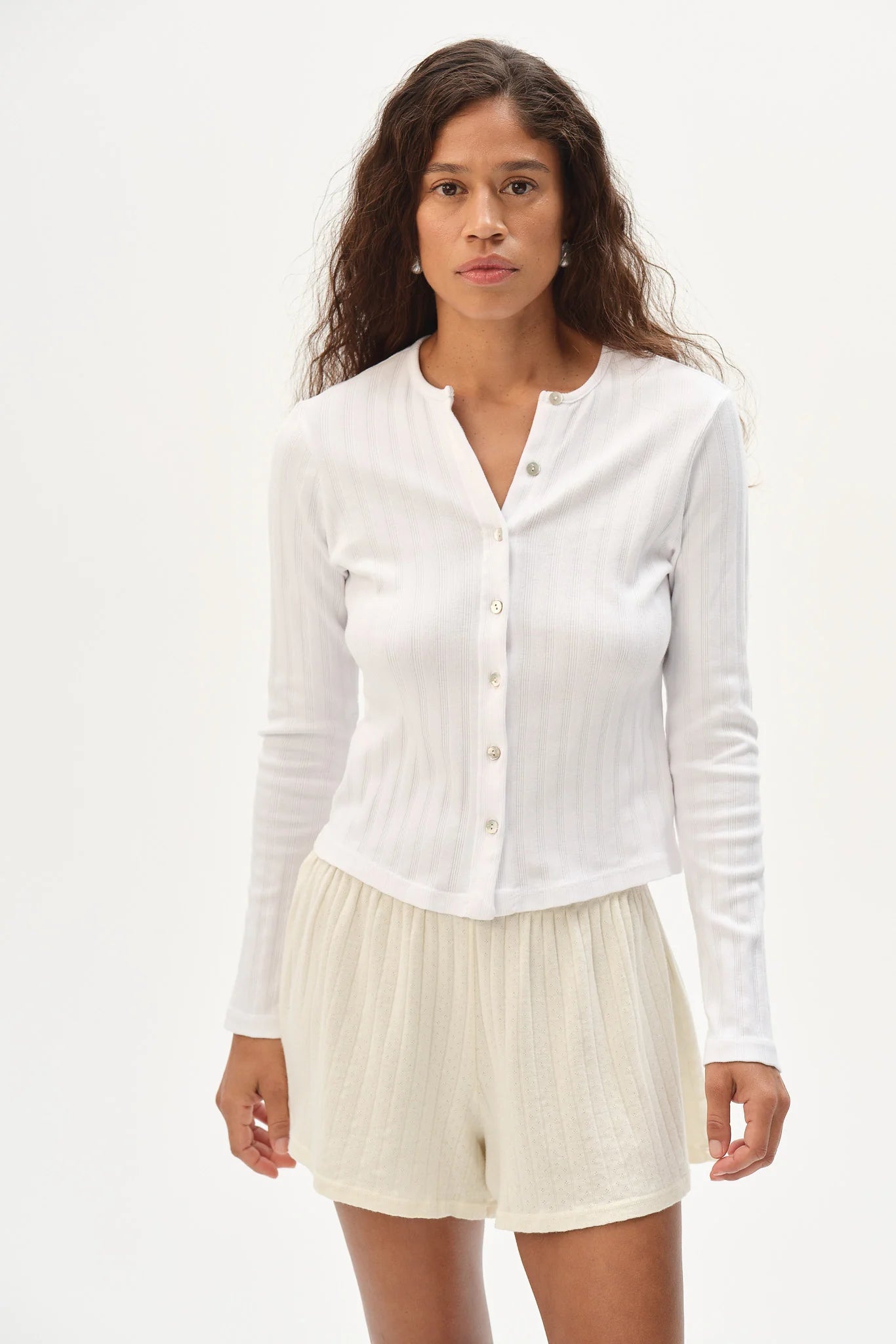 DONNI. Varied Rib Cardigan in Powder light blue organic cotton with button front.